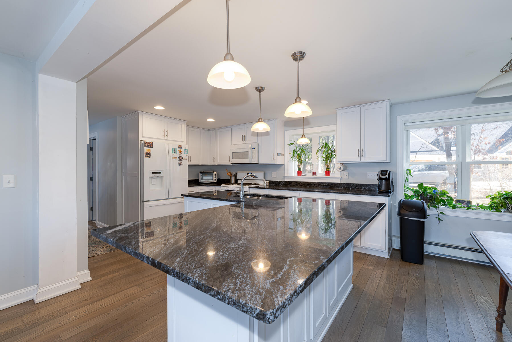 65 Santuit Lane Mashpee, MA 02649 - Photo 11 of 52 a large kitchen with stainless steel appliances granite countertop a sink a stove and a wooden floors