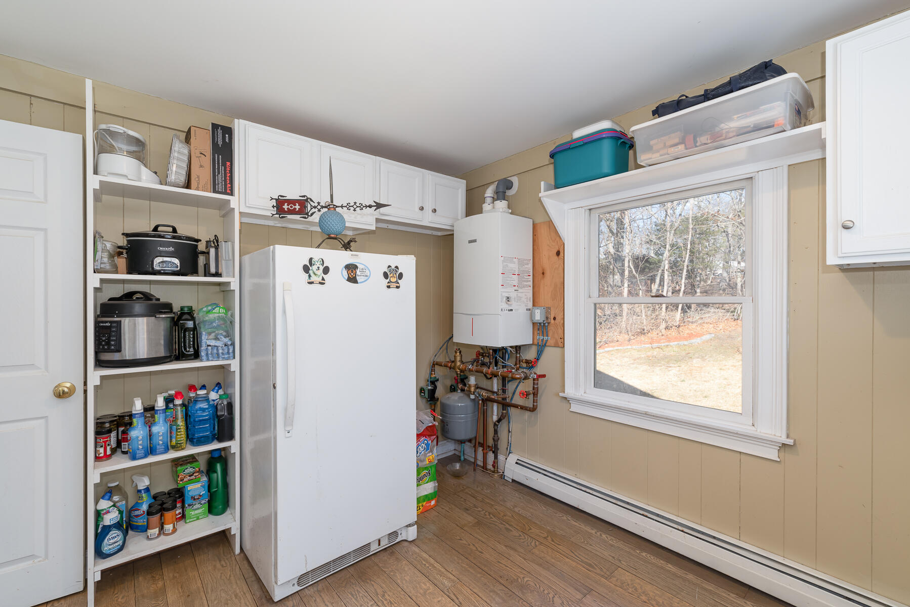65 Santuit Lane Mashpee, MA 02649 - Photo 25 of 52 a white refrigerator freezer sitting in a kitchen next to a window