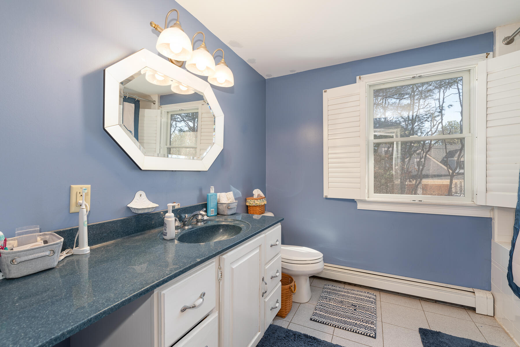 65 Santuit Lane Mashpee, MA 02649 - Photo 31 of 52 a bathroom with a toilet a sink and mirror