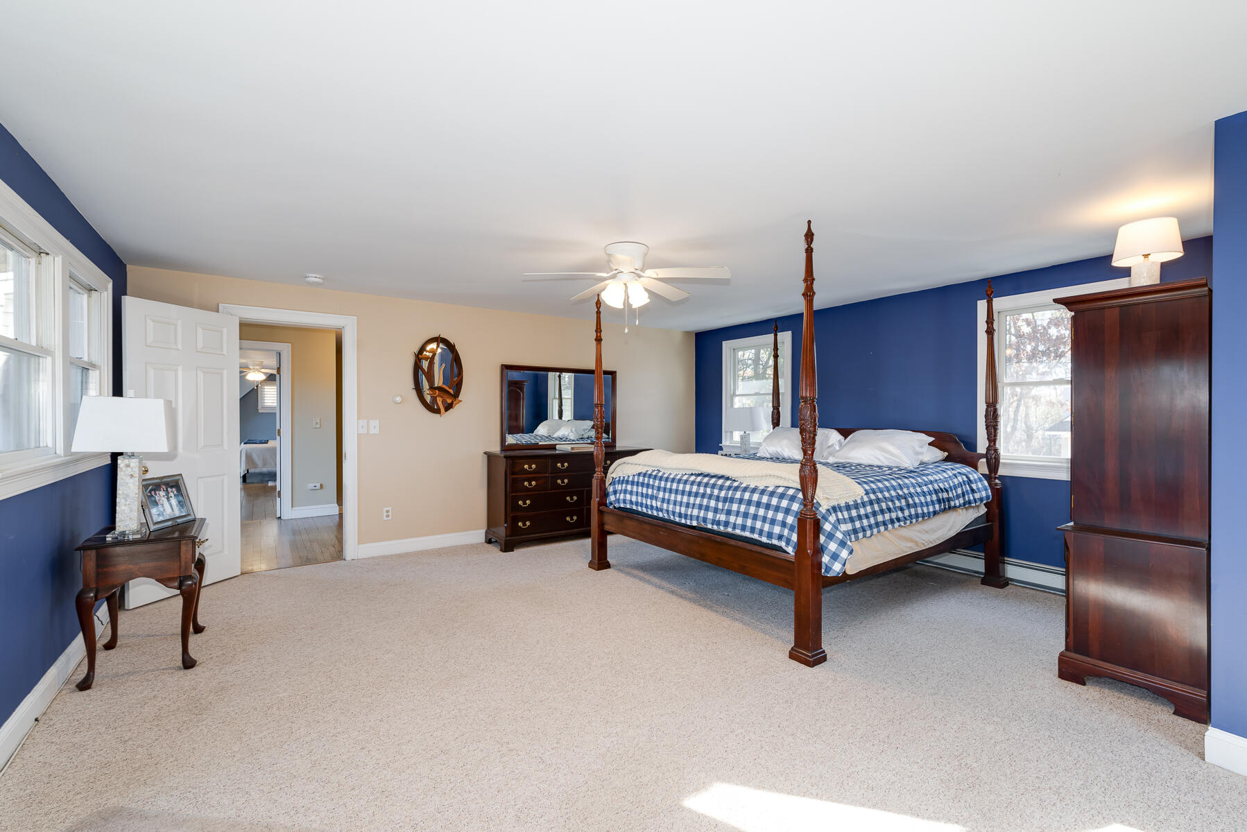 65 Santuit Lane Mashpee, MA 02649 - Photo 34 of 52 a bedroom with a bed and a chandelier