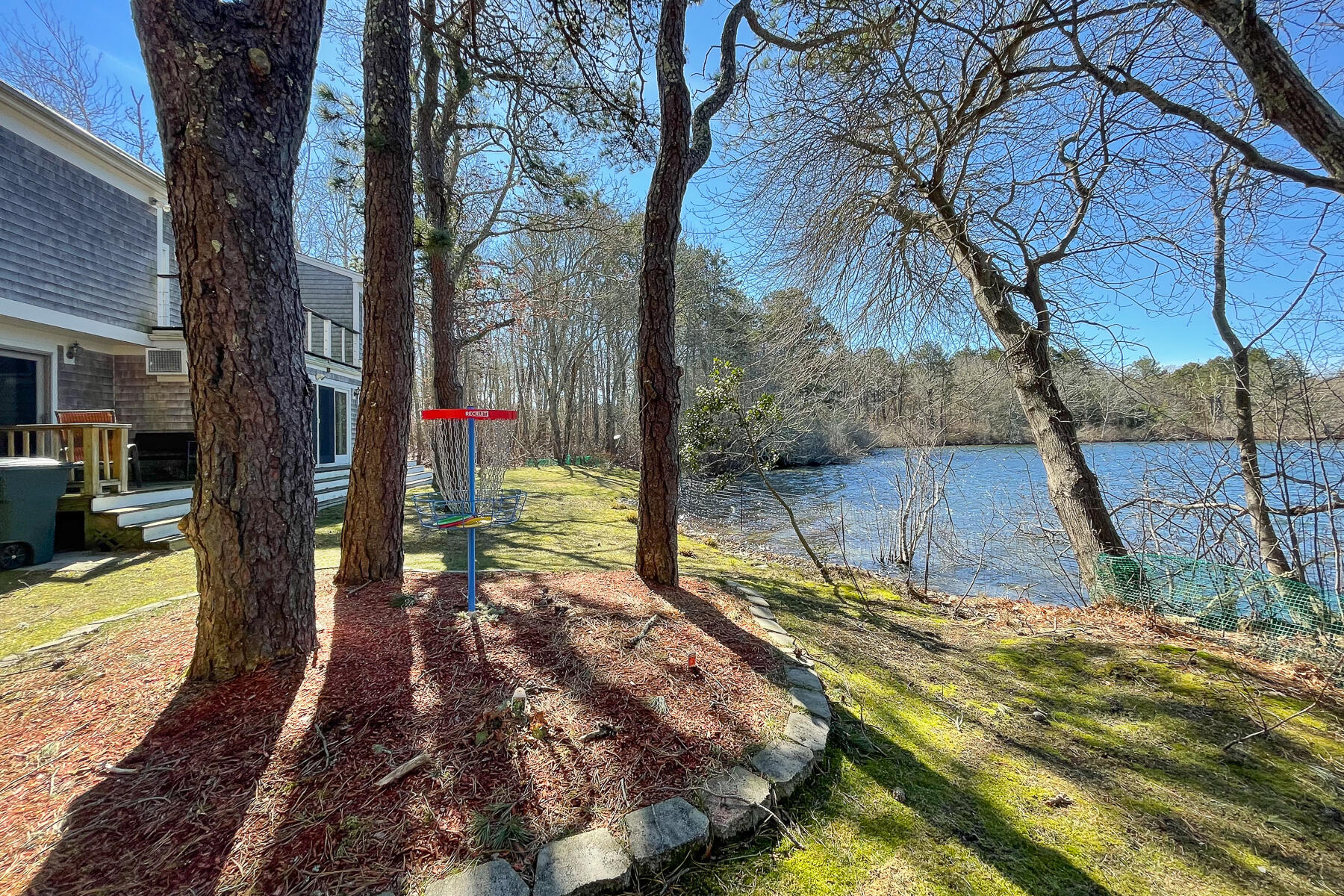 65 Santuit Lane Mashpee, MA 02649 - Photo 43 of 52 a backyard of a house with lots of green space