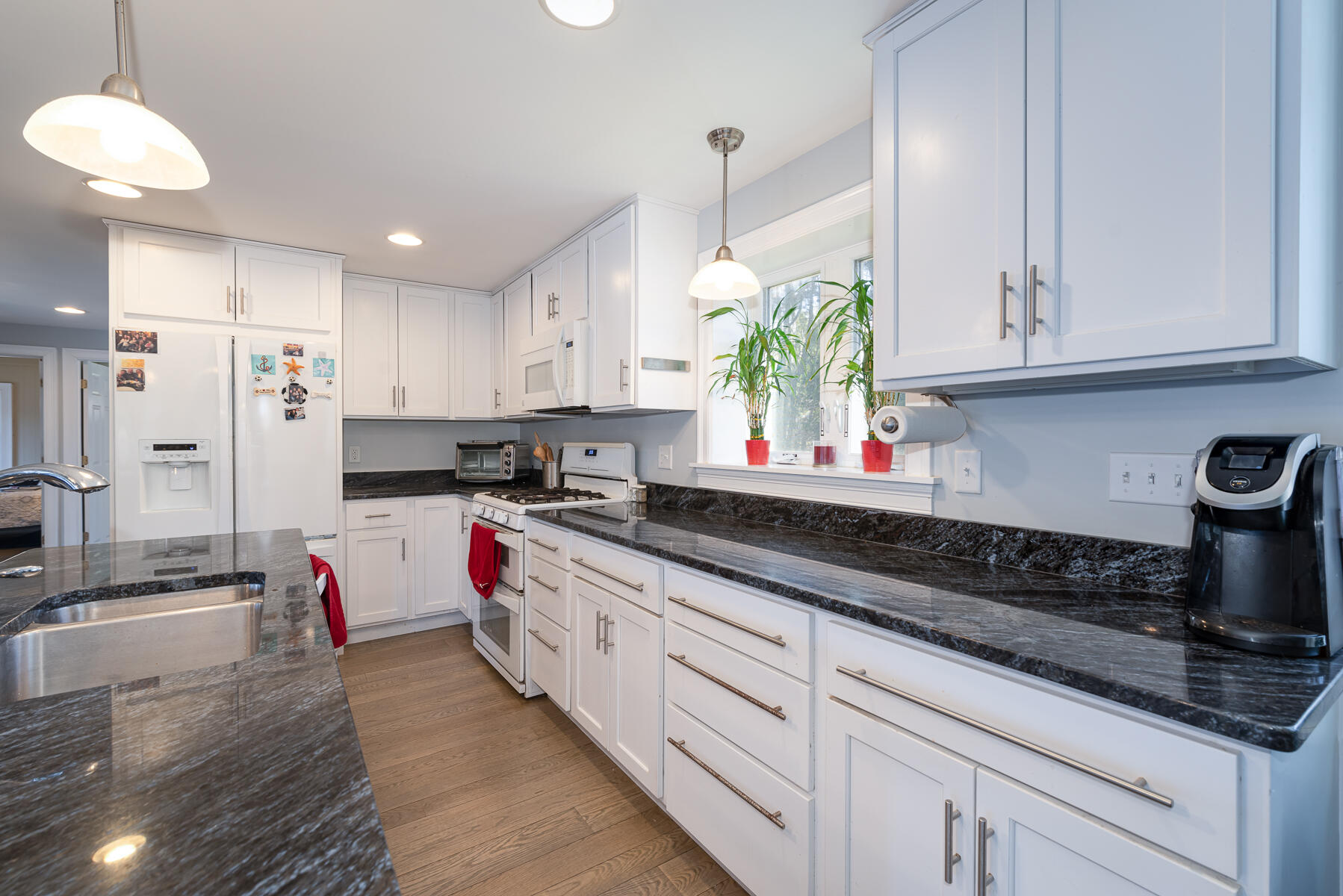 65 Santuit Lane Mashpee, MA 02649 - Photo 9 of 52 a kitchen with granite countertop a stove a sink and a refrigerator