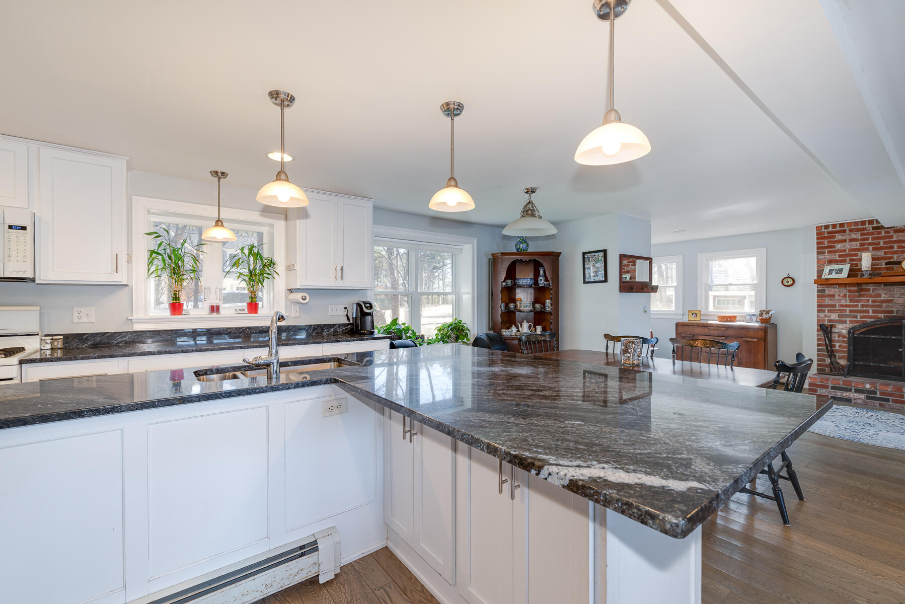 65 Santuit Lane Mashpee, MA 02649 - Photo 10 of 52 a kitchen with stainless steel appliances granite countertop a sink a stove and a wooden floors