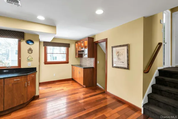 a view of a kitchen with wooden floor and stairs