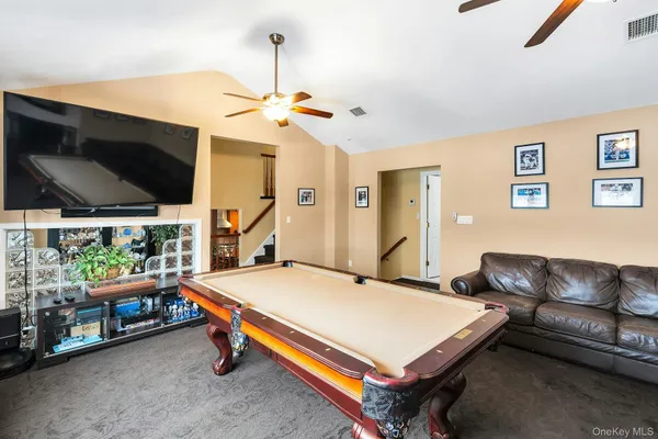 a room with pool table and flat screen tv