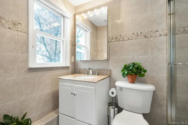 a bathroom with a toilet sink and mirror