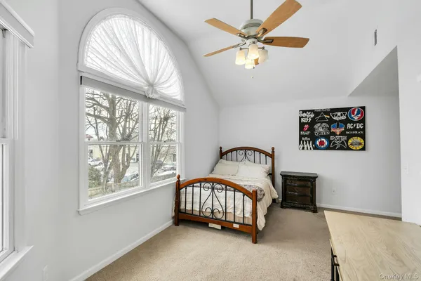 a bedroom with a bed and a large window