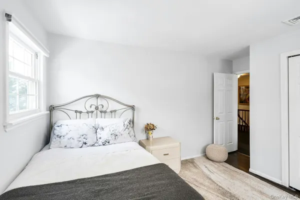 a room with a bed and wooden floor