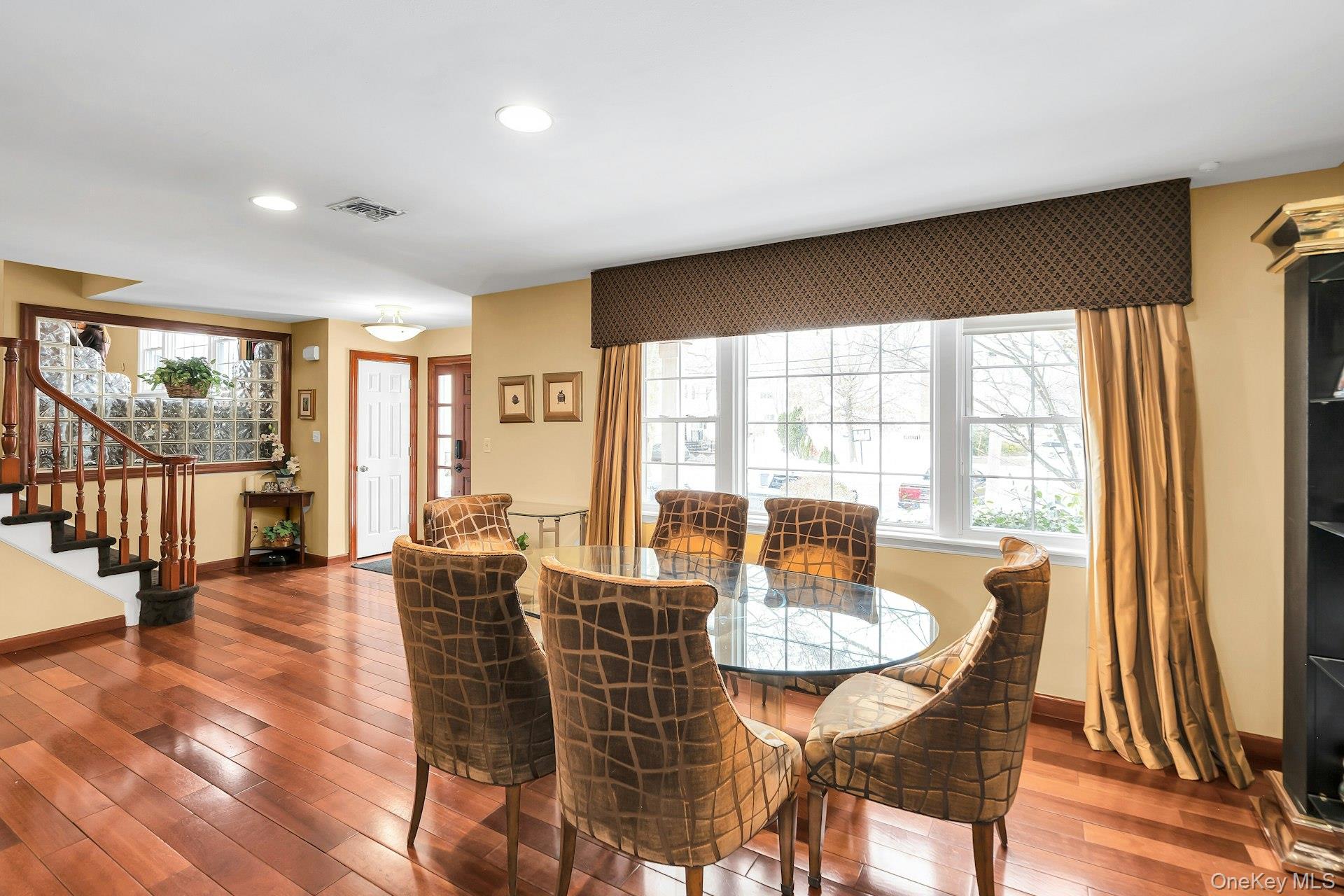 2043 Ripley Lane Merrick, NY 11566 - Photo 7 of 37 a dining room with furniture window and wooden floor