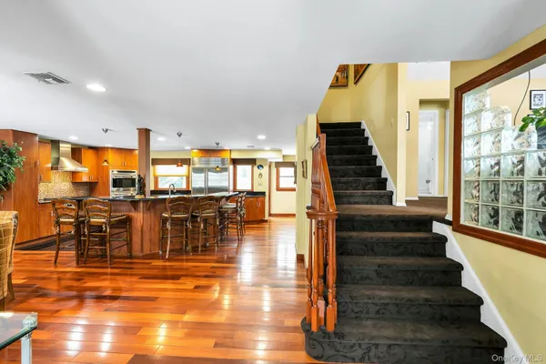 a view of a living room with balcony and dining space