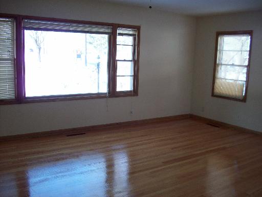 1223 North Main Street Wheaton, IL 60187 - Photo 4 of 6 an empty room with wooden floor and windows