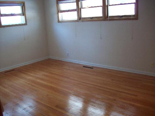 1223 North Main Street Wheaton, IL 60187 - Photo 5 of 6 an empty room with wooden floor and windows