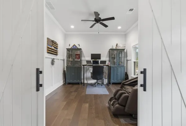 a kitchen with stainless steel appliances granite countertop a stove a refrigerator a kitchen island a sink and chairs