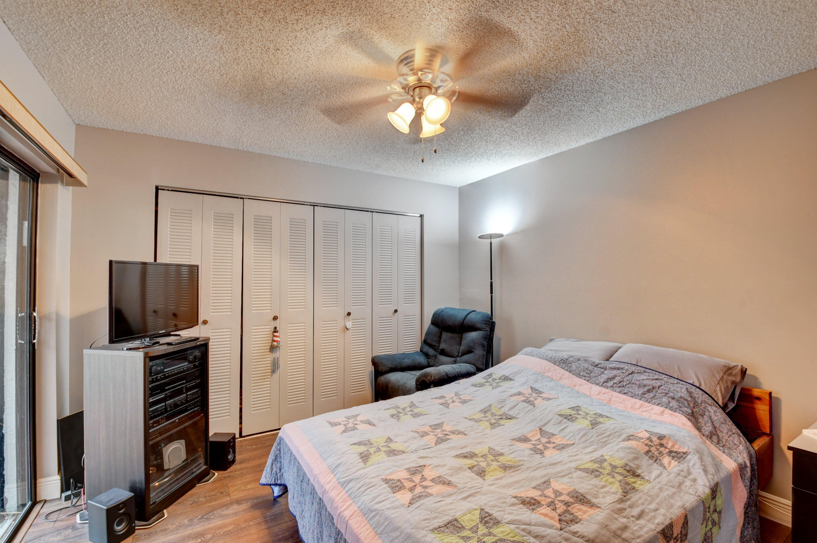 9142 Southwest 22nd Street, Unit D Boca Raton, FL 33428 - Photo 16 of 36 a bedroom with a bed and a flat screen tv