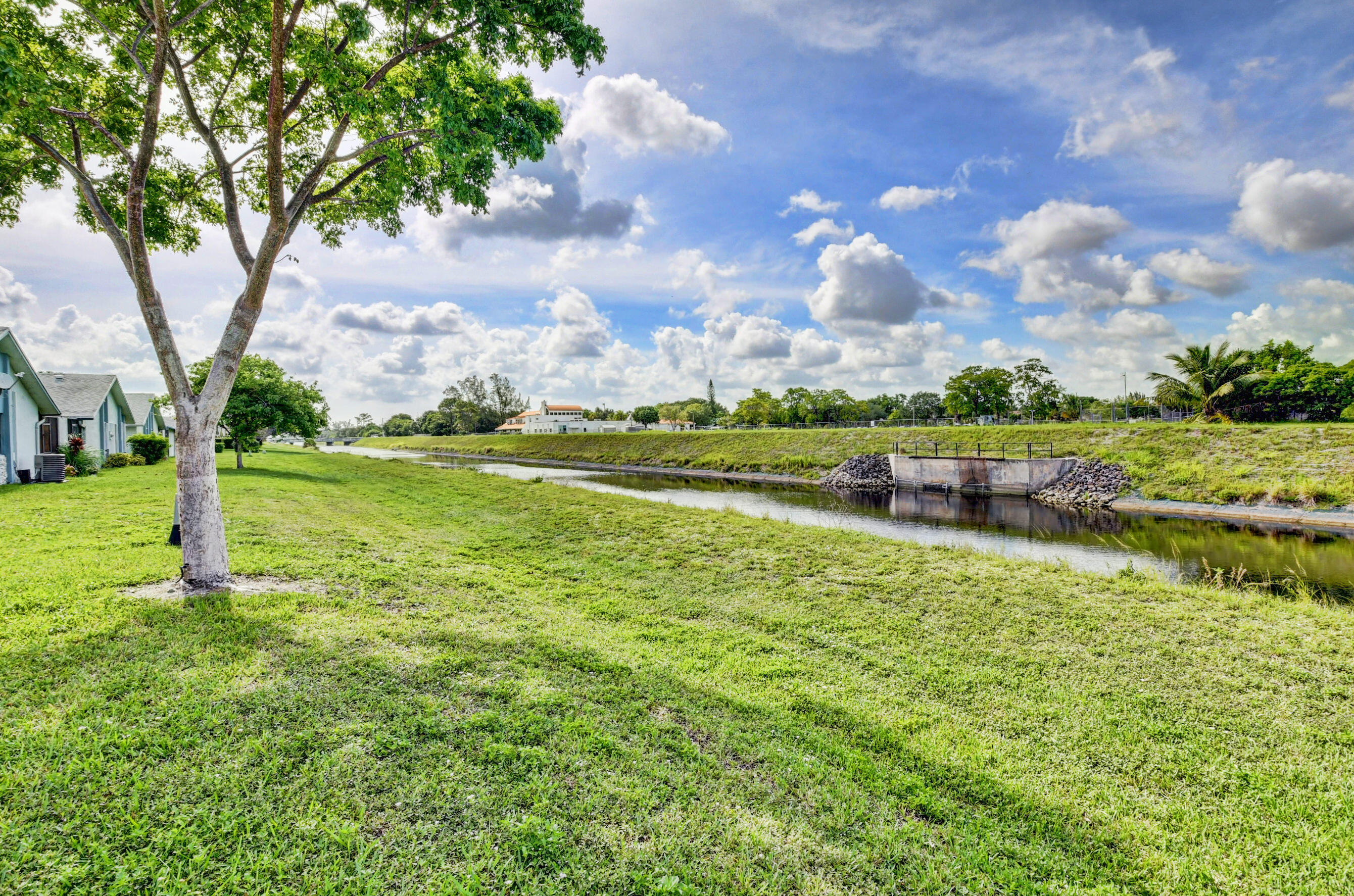 9142 Southwest 22nd Street, Unit D Boca Raton, FL 33428 - Photo 29 of 36 a yard with lots of green space and trees