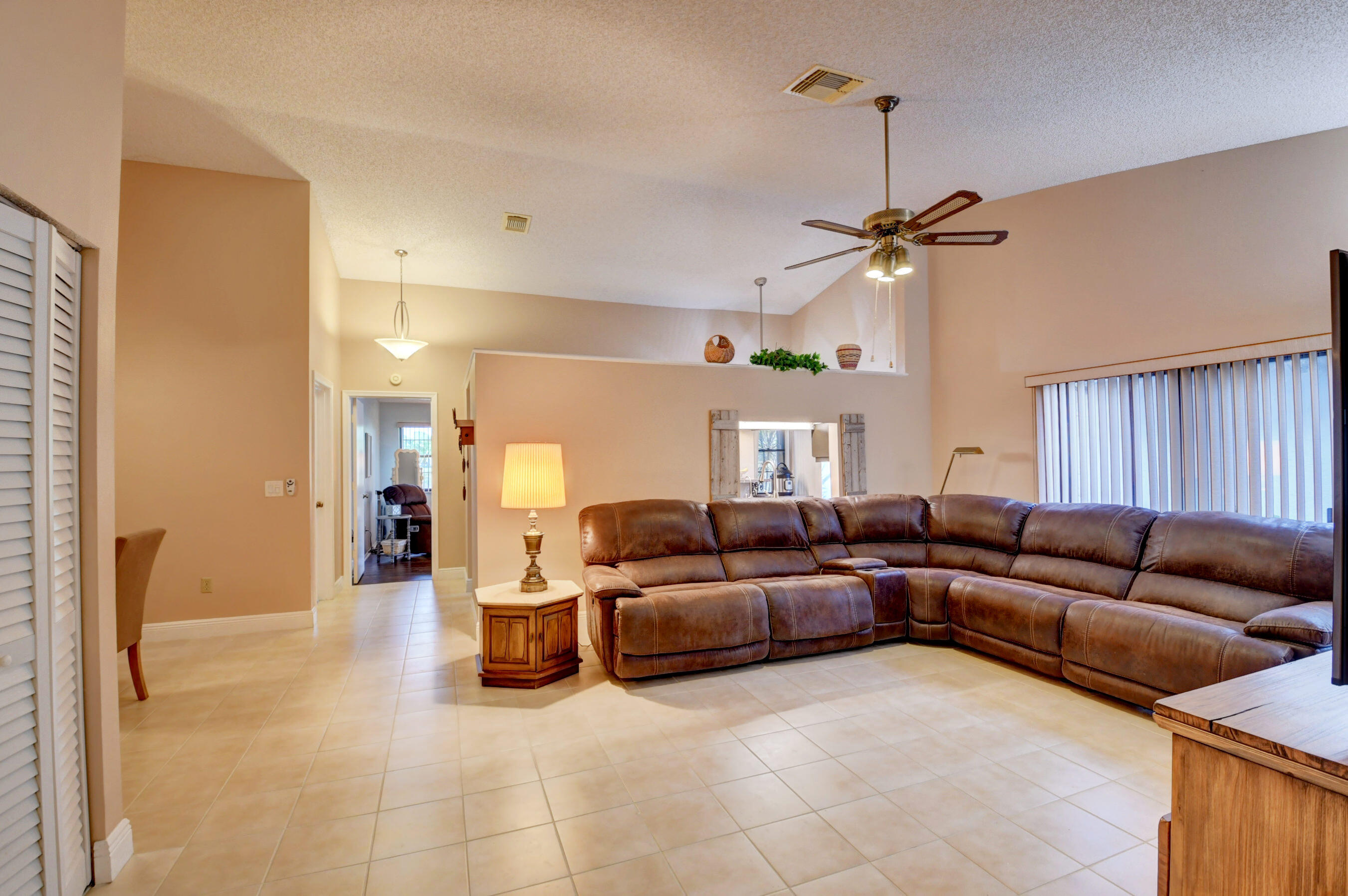 9142 Southwest 22nd Street, Unit D Boca Raton, FL 33428 - Photo 4 of 36 a living room with furniture a ceiling fan and a window