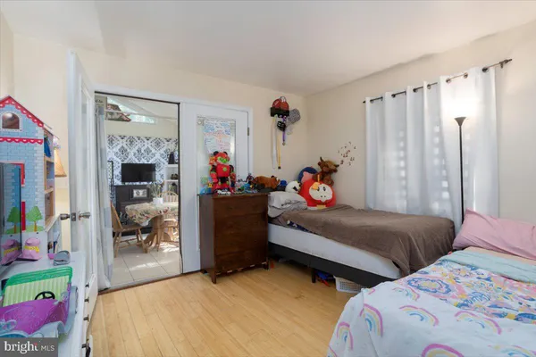 a bedroom with two beds and a window