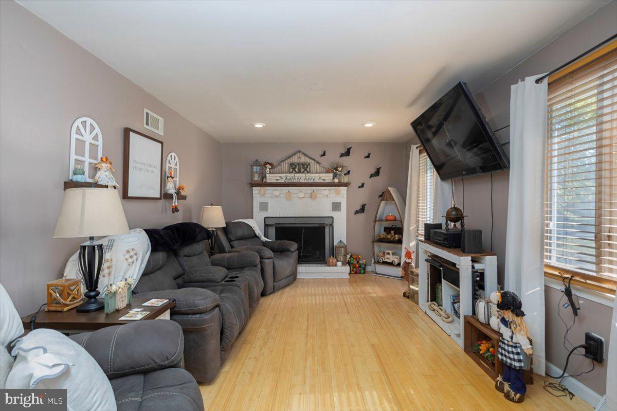 311 Kerr Avenue Denton, MD 21629 - Photo 5 of 22 a living room with furniture a flat screen tv and a fireplace