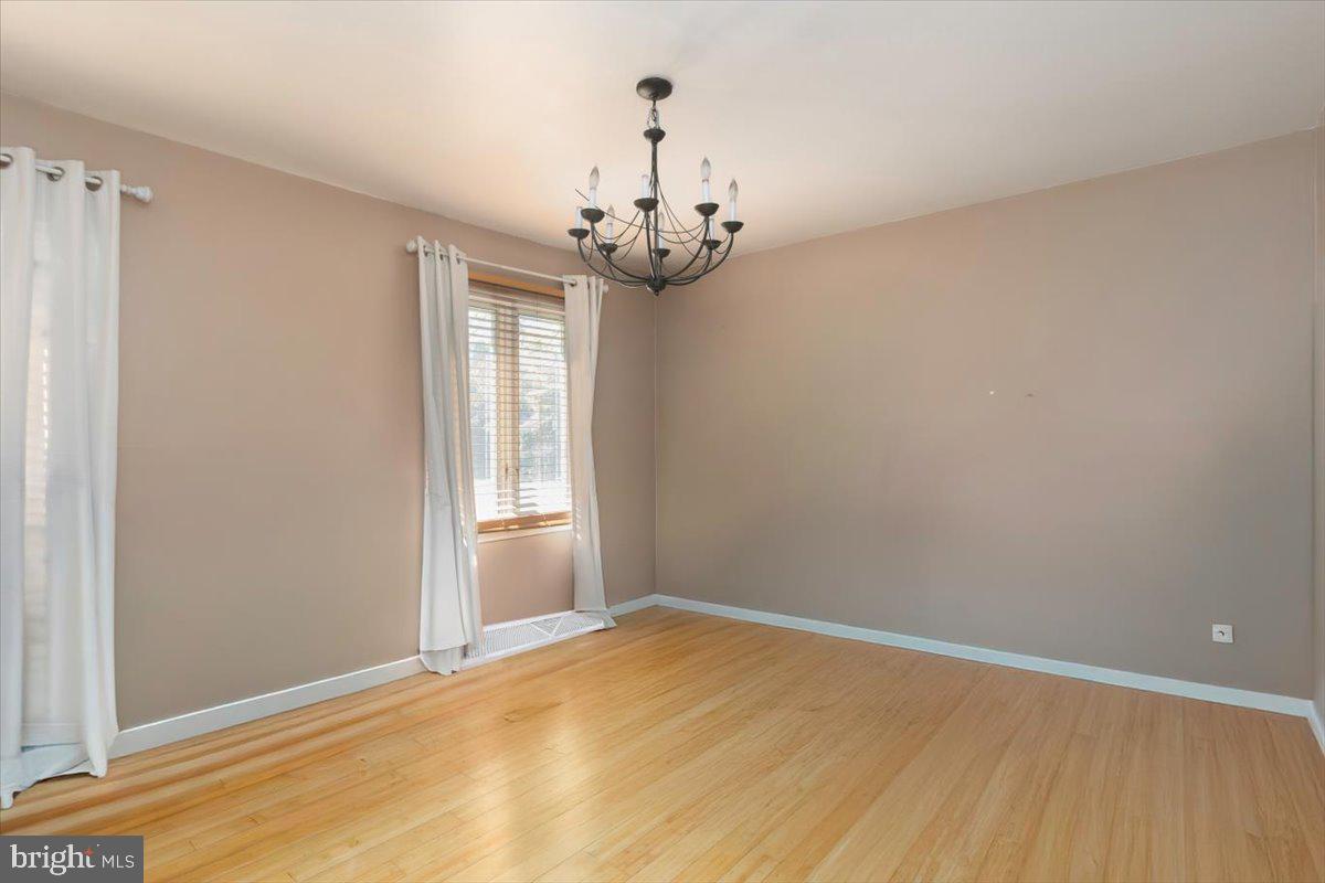 311 Kerr Avenue Denton, MD 21629 - Photo 7 of 22 a view of empty room with wooden floor and chandelier