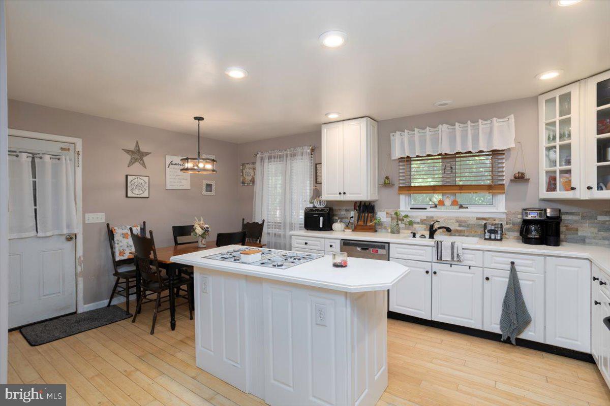 311 Kerr Avenue Denton, MD 21629 - Photo 8 of 22 a kitchen with a sink a counter top space stainless steel appliances and cabinets