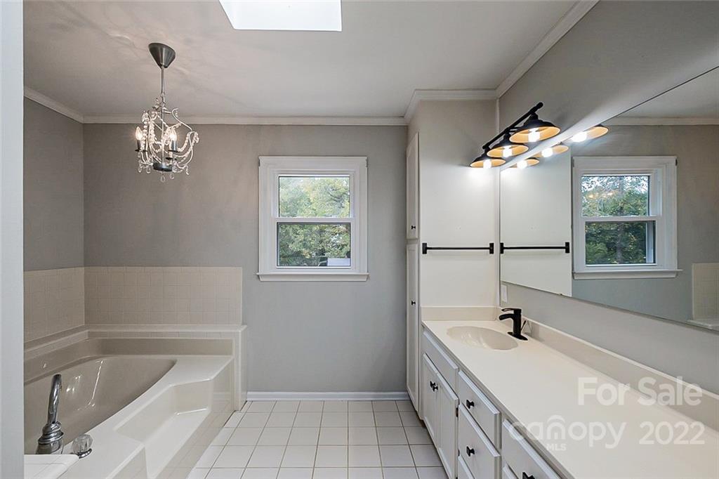 2927 Trotters Road Gastonia, NC 28054 - Photo 11 of 16 a bathroom with a tub sink and mirror