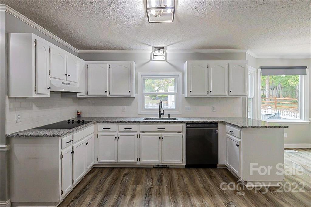 2927 Trotters Road Gastonia, NC 28054 - Photo 4 of 16 a kitchen with granite countertop white cabinets and white appliances