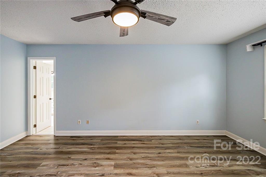 2927 Trotters Road Gastonia, NC 28054 - Photo 6 of 16 a view of a room with wooden floor and ceiling fan