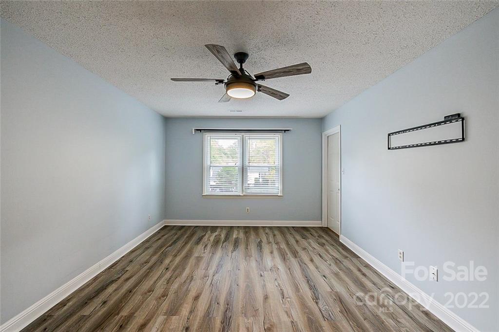 2927 Trotters Road Gastonia, NC 28054 - Photo 7 of 16 wooden floor in an empty room with a window