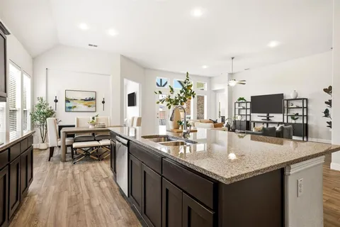 a kitchen with granite countertop kitchen island stainless steel appliances a sink and counter space
