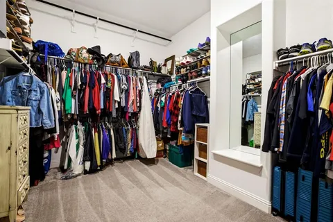 a view of walk in closet with clothes