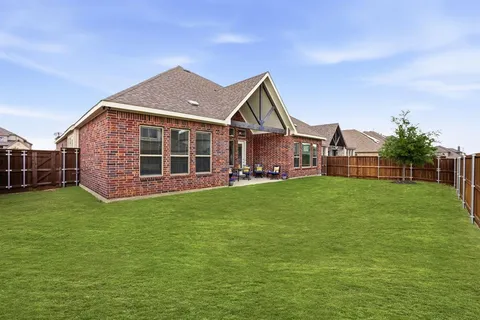 an aerial view of a residential houses with outdoor space