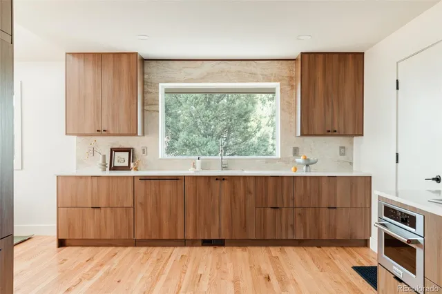 a kitchen with granite countertop a refrigerator and cabinets