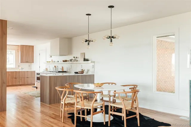 a living room with furniture fireplace and a large window