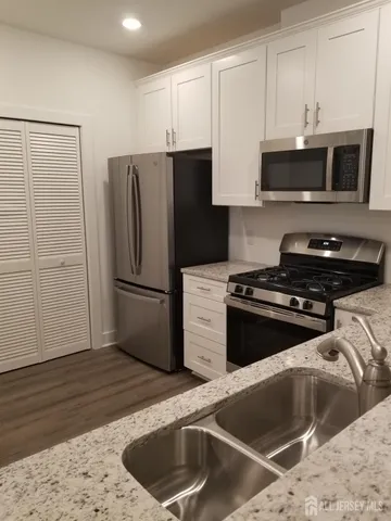 a kitchen with a refrigerator stove and microwave