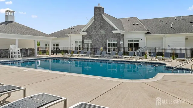 a swimming pool view with a outdoor seating