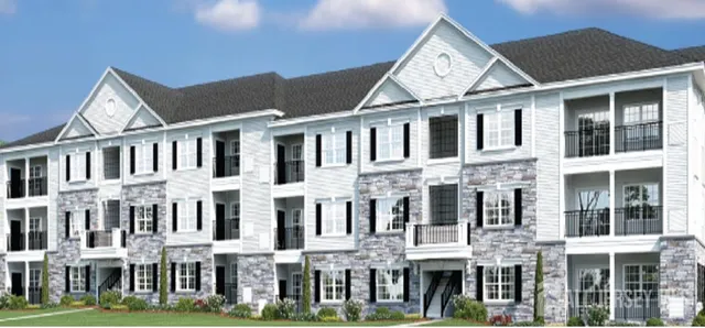 a front view of a residential apartment building with a yard