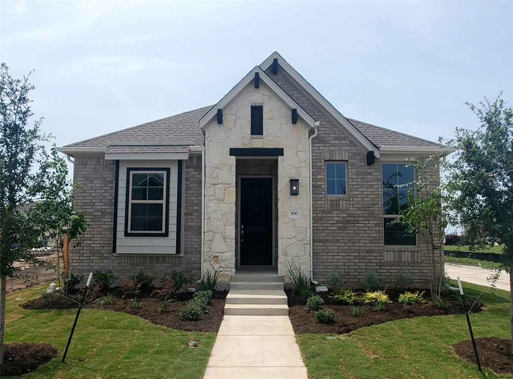 100 Royal Fern Road Hutto, TX 78634 - Photo 1 of 1 a front view of a house with garden