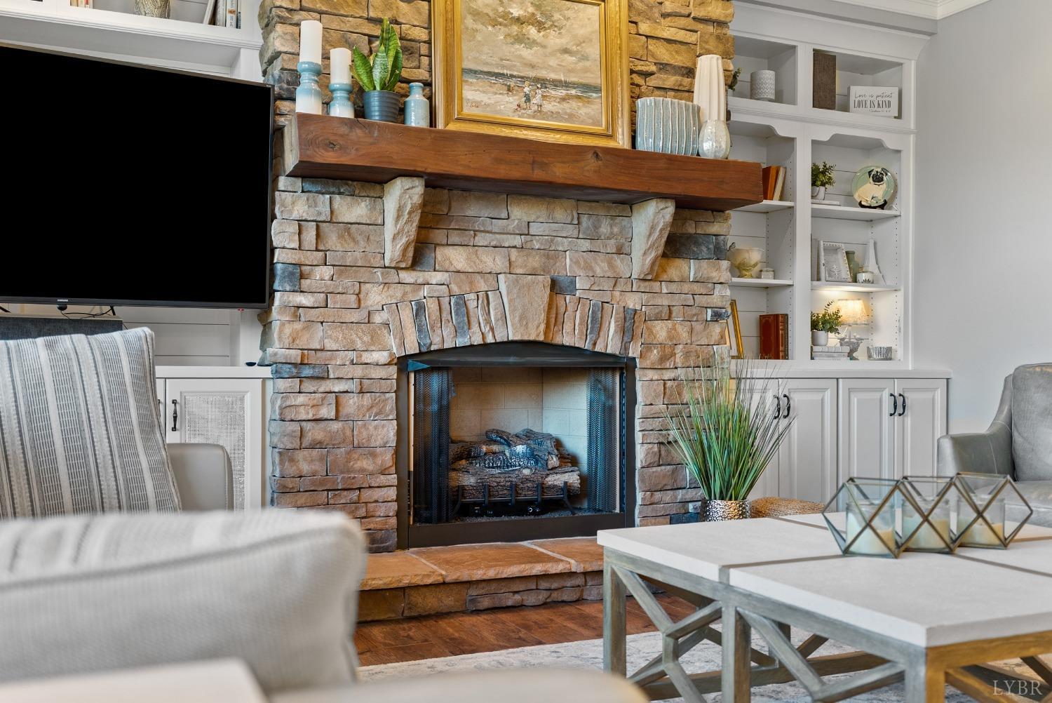 1249 Lees Mill Lane Goode, VA 24556 - Photo 12 of 98 a living room with furniture a flat screen tv and a fireplace