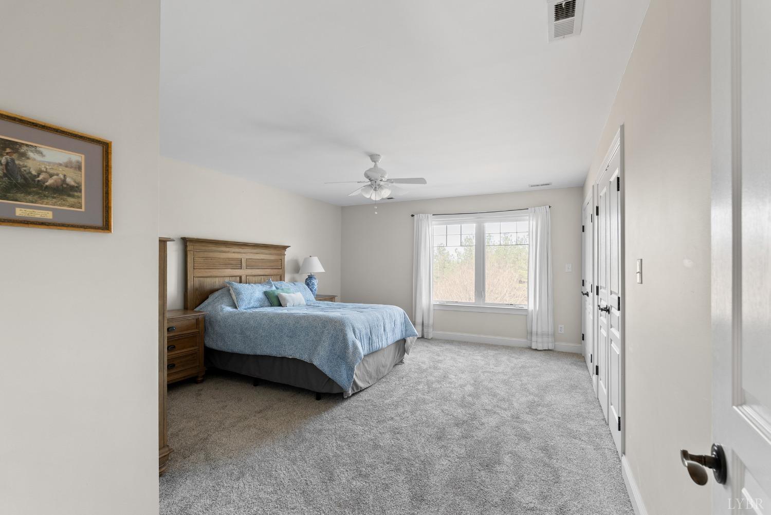 1249 Lees Mill Lane Goode, VA 24556 - Photo 35 of 98 a spacious bedroom with a bed and a window