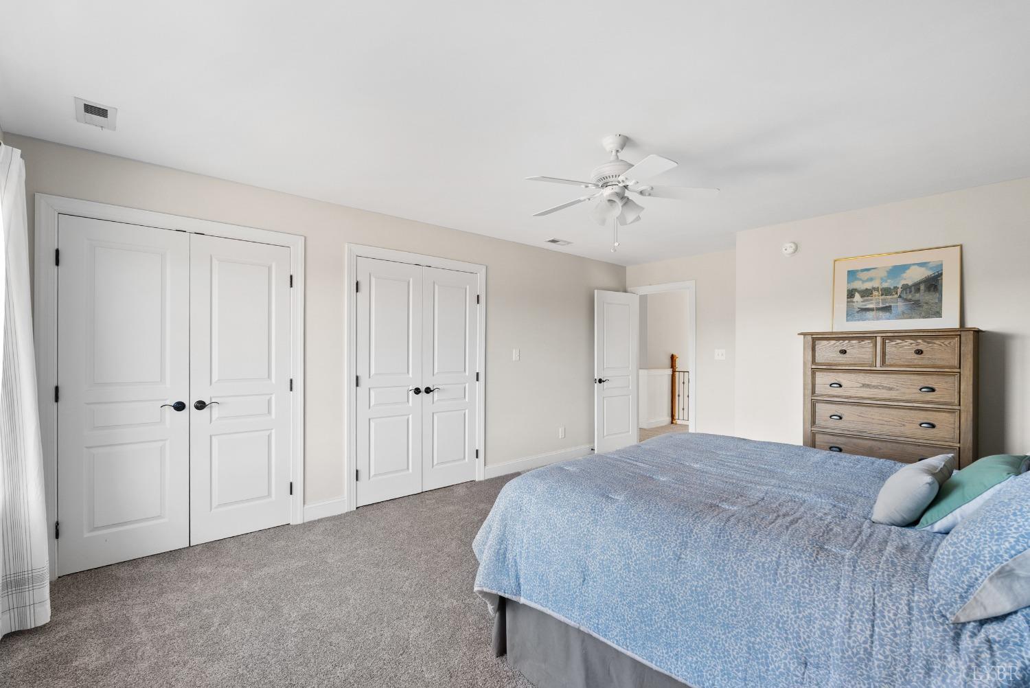 1249 Lees Mill Lane Goode, VA 24556 - Photo 36 of 98 a bedroom with a bed and a chandelier