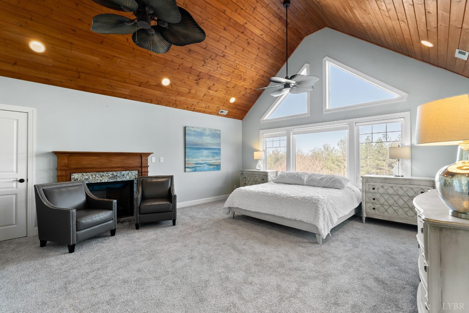 1249 Lees Mill Lane Goode, VA 24556 - Photo 45 of 98 a spacious bedroom with a bed and a chandelier