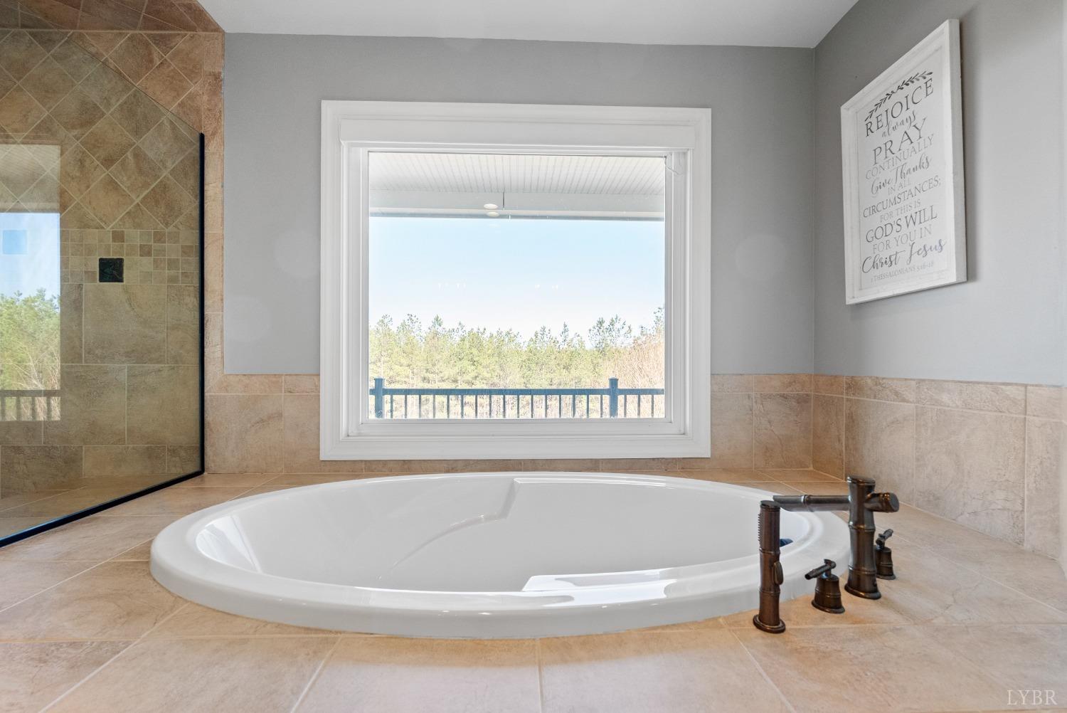1249 Lees Mill Lane Goode, VA 24556 - Photo 54 of 98 a white bath tub sitting in a bathroom next to a window