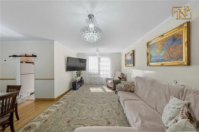 a bedroom with furniture and a flat screen tv