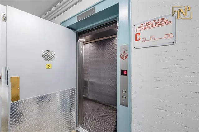 a utility room with fridge and window