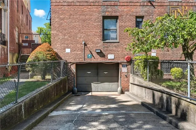 a view of a brick house with a yard