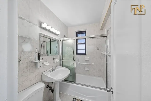 a bathroom with a sink mirror toilet and shower