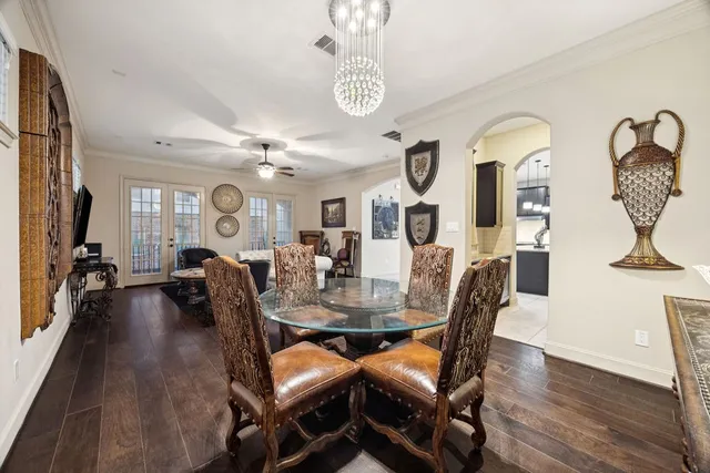a view of a dining room with furniture a chandelier and wooden floor