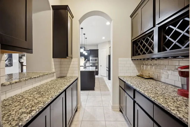 a kitchen with stainless steel appliances granite countertop a sink and a counter space