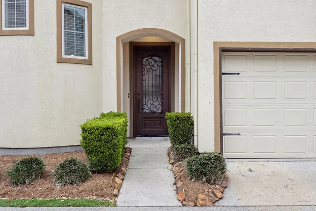 a front view of a house with potted plants