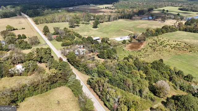 a front view of house with yard outdoor seating and large tree